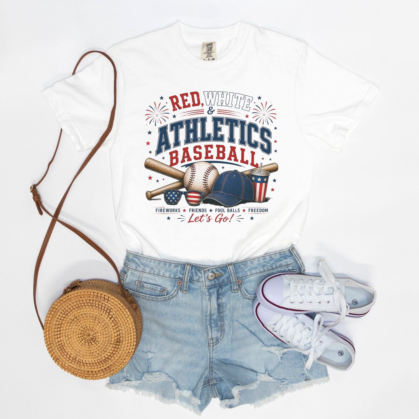 White t-shirt with 'Red White & Athletics Baseball' design, denim shorts, white sneakers, and round brown bag on a white background.