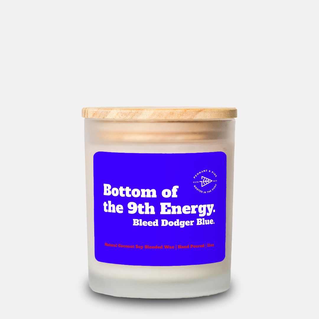 Candle with a blue label and wooden lid on a white background