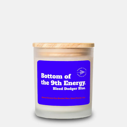 Candle with a blue label and wooden lid on a white background