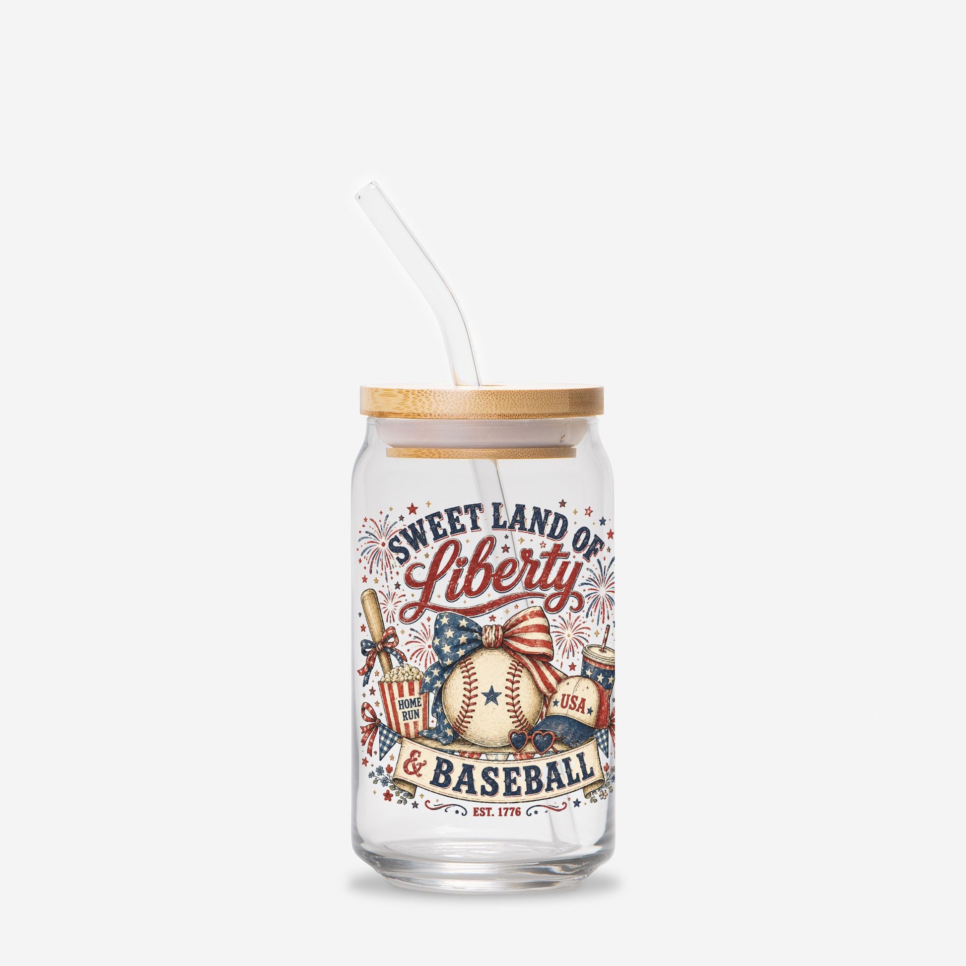 Glass tumbler with straw featuring 'Sweet Land of Liberty & Baseball' design on a white background