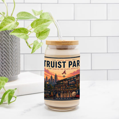 Jar with a 'Truist Park' label on a white surface with a plant in the background