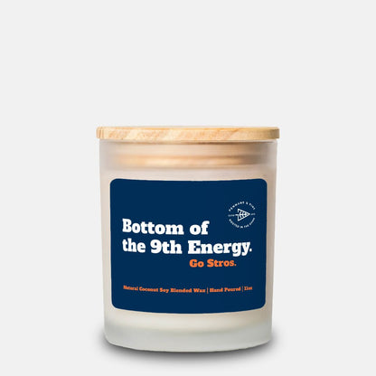 Candle with a blue label and wooden lid on a white background