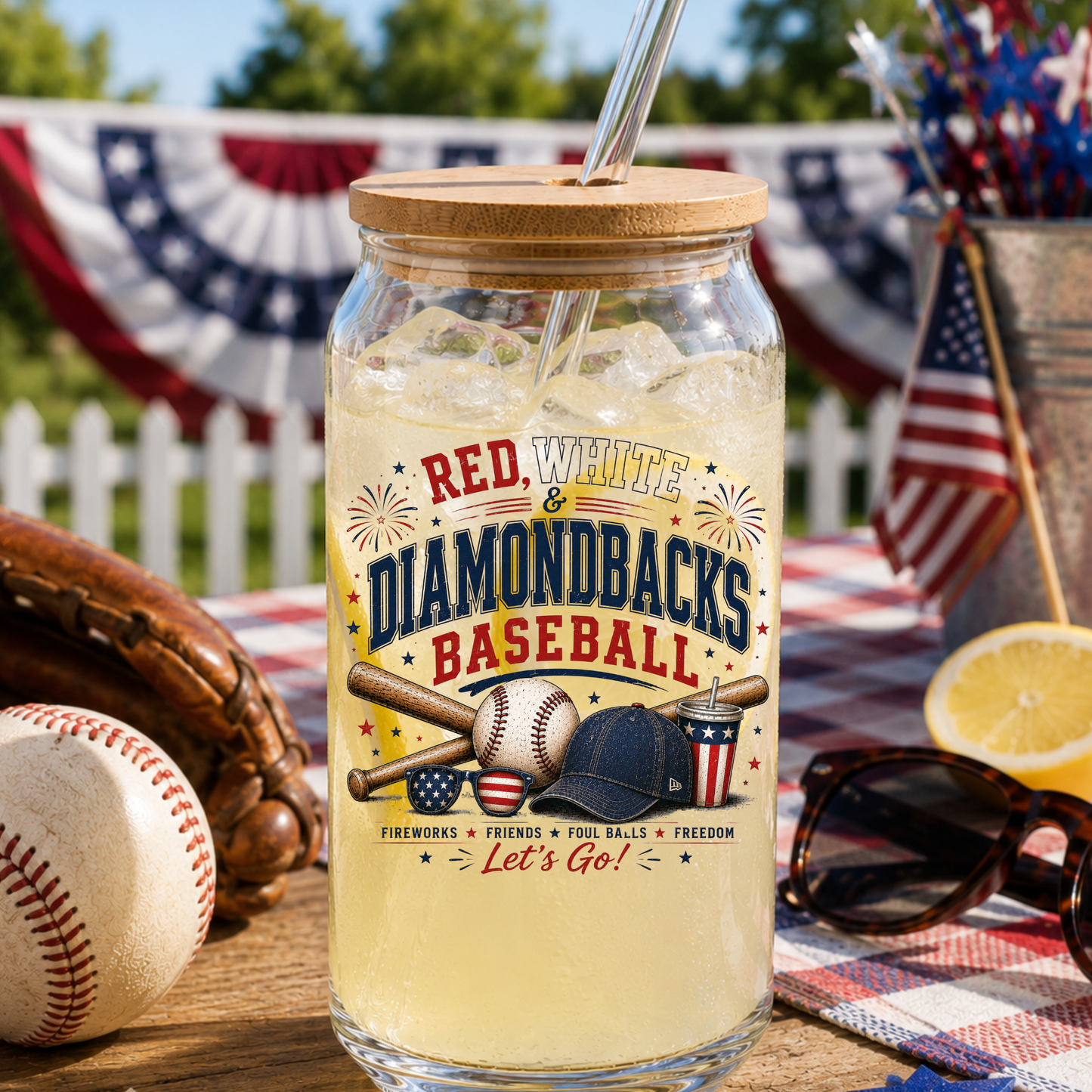 Glass jar with a straw lid, filled with iced beverage, on a table with baseball-themed decor.
