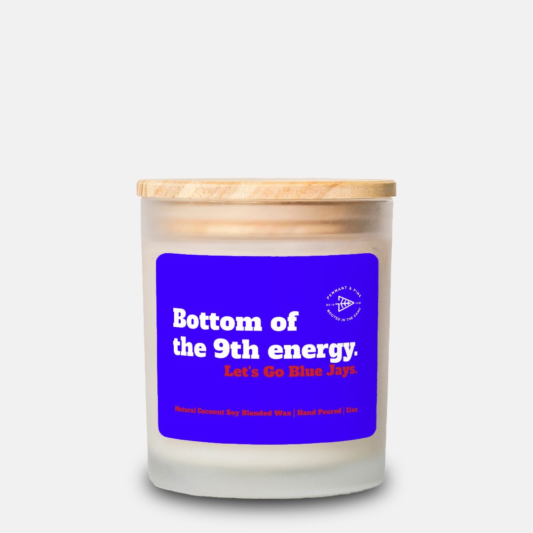 Candle with a blue label and wooden lid on a white background