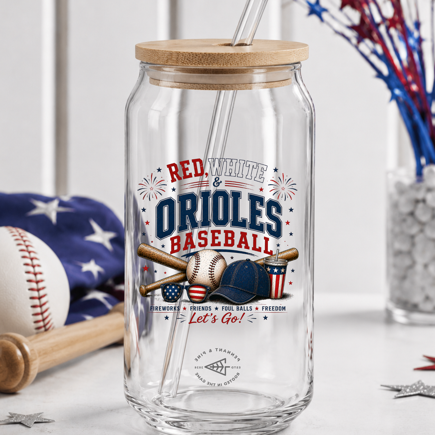 Clear glass tumbler with wooden lid and straw, featuring 'Red White & Orioles Baseball' design.