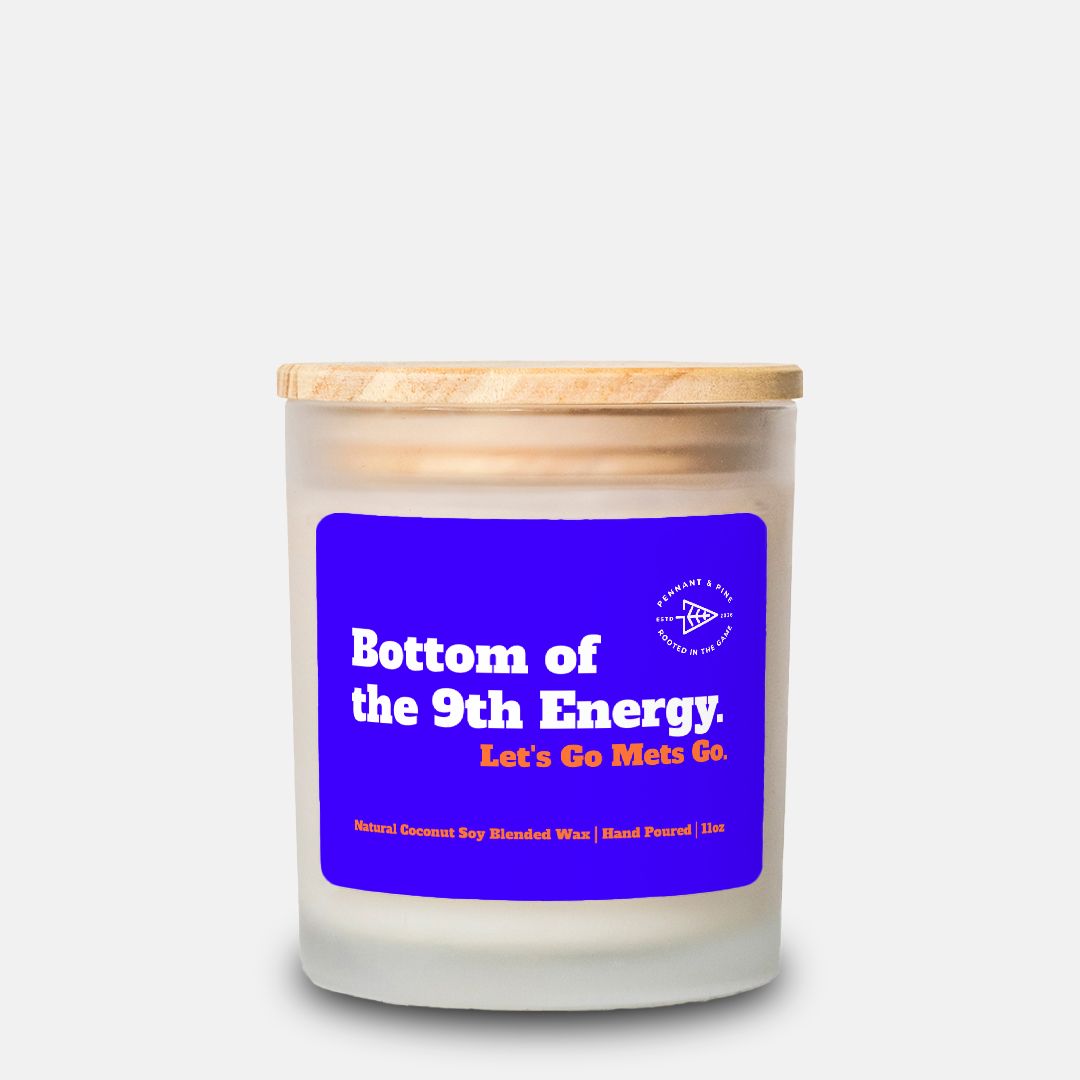 Candle with a blue label and wooden lid on a white background