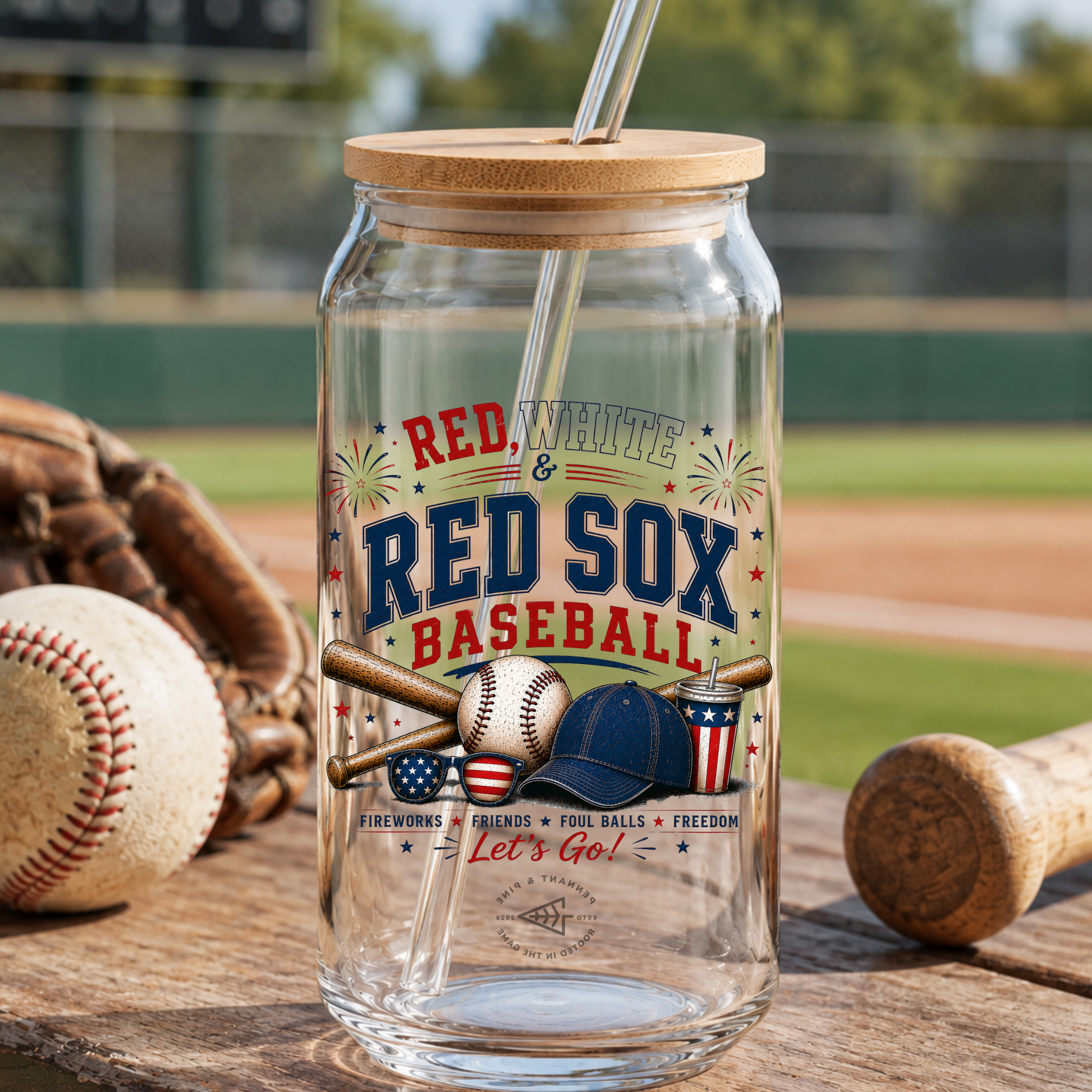 Glass tumbler with wooden lid and straw, featuring Red Sox baseball design, on a baseball field background.