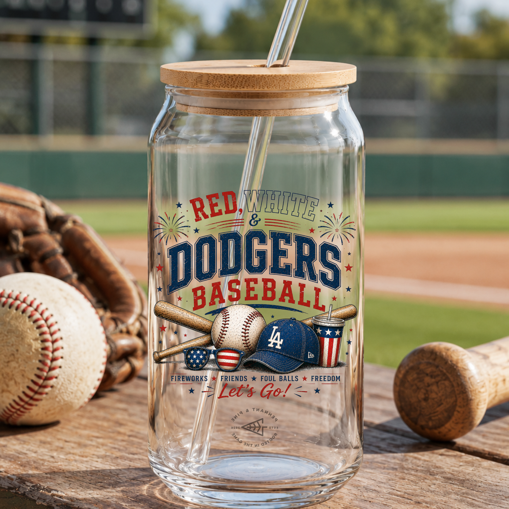 Glass tumbler with wooden lid and straw, featuring Dodgers baseball design, on a baseball field background.