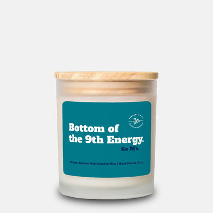 Candle with a wooden lid and blue label on a white background