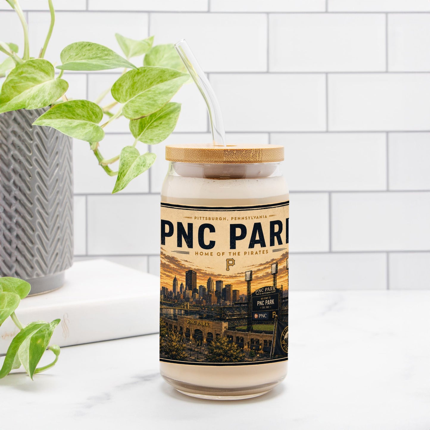 Jar with a label featuring 'PNC Park' on a white surface with a plant in the background