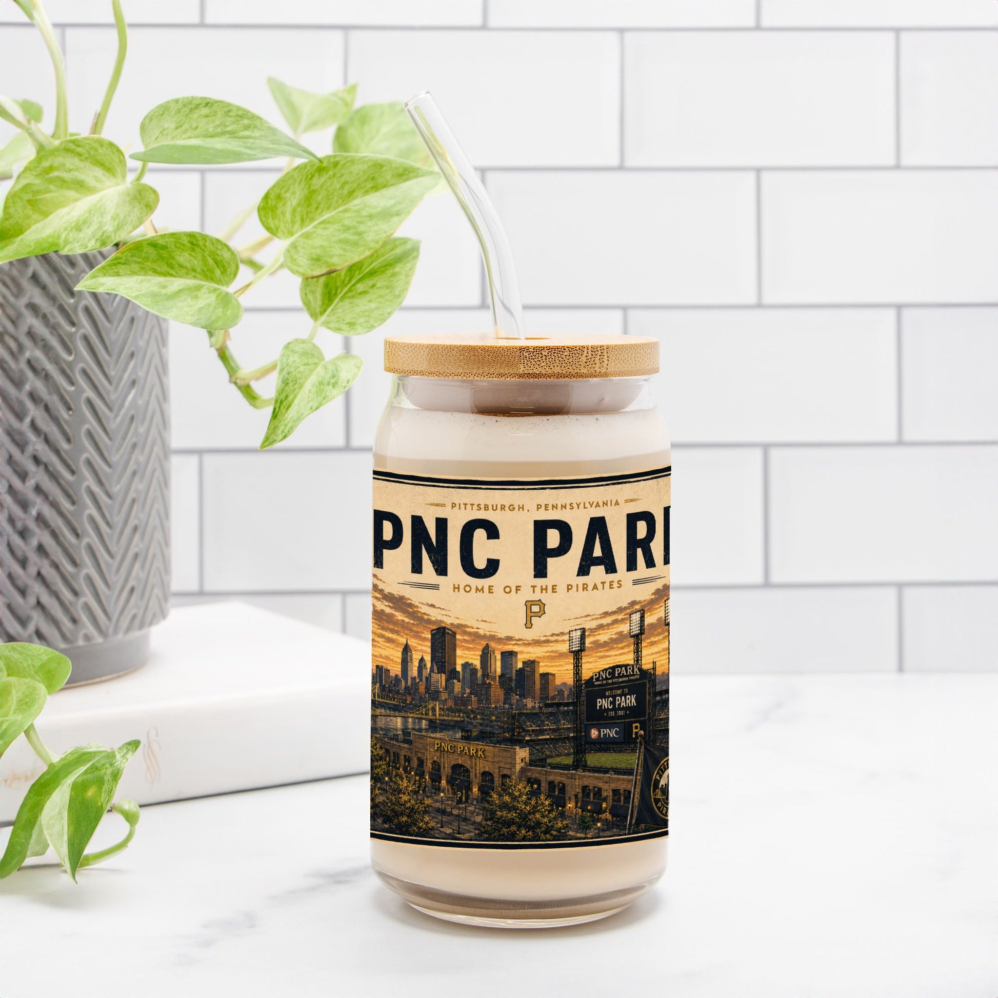 Jar with a label featuring 'PNC Park' on a white surface with a plant in the background
