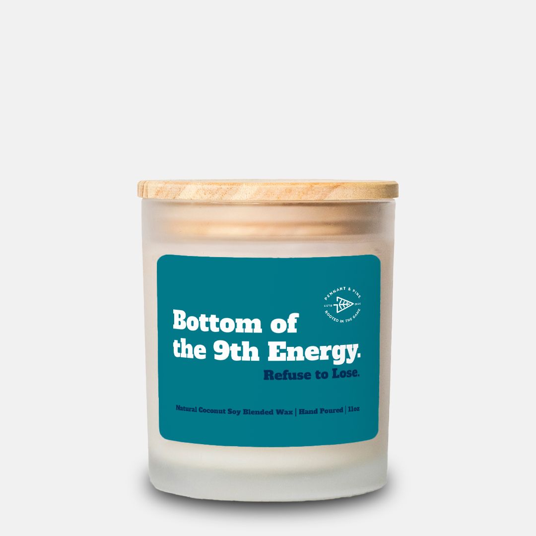 Candle with a blue label and wooden lid on a white background