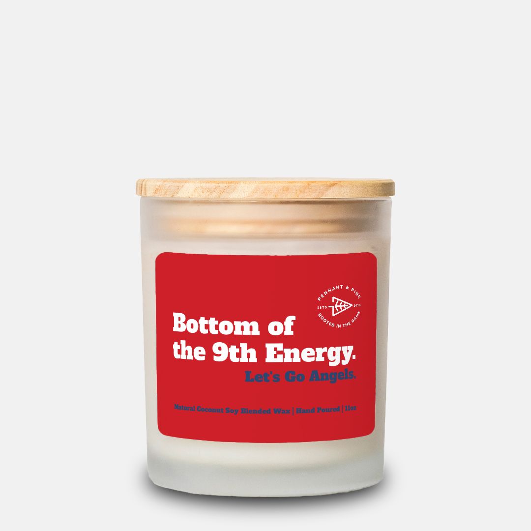 Candle with a red label and wooden lid on a white background