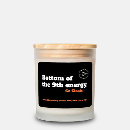 Candle with a wooden lid and black label on a white background