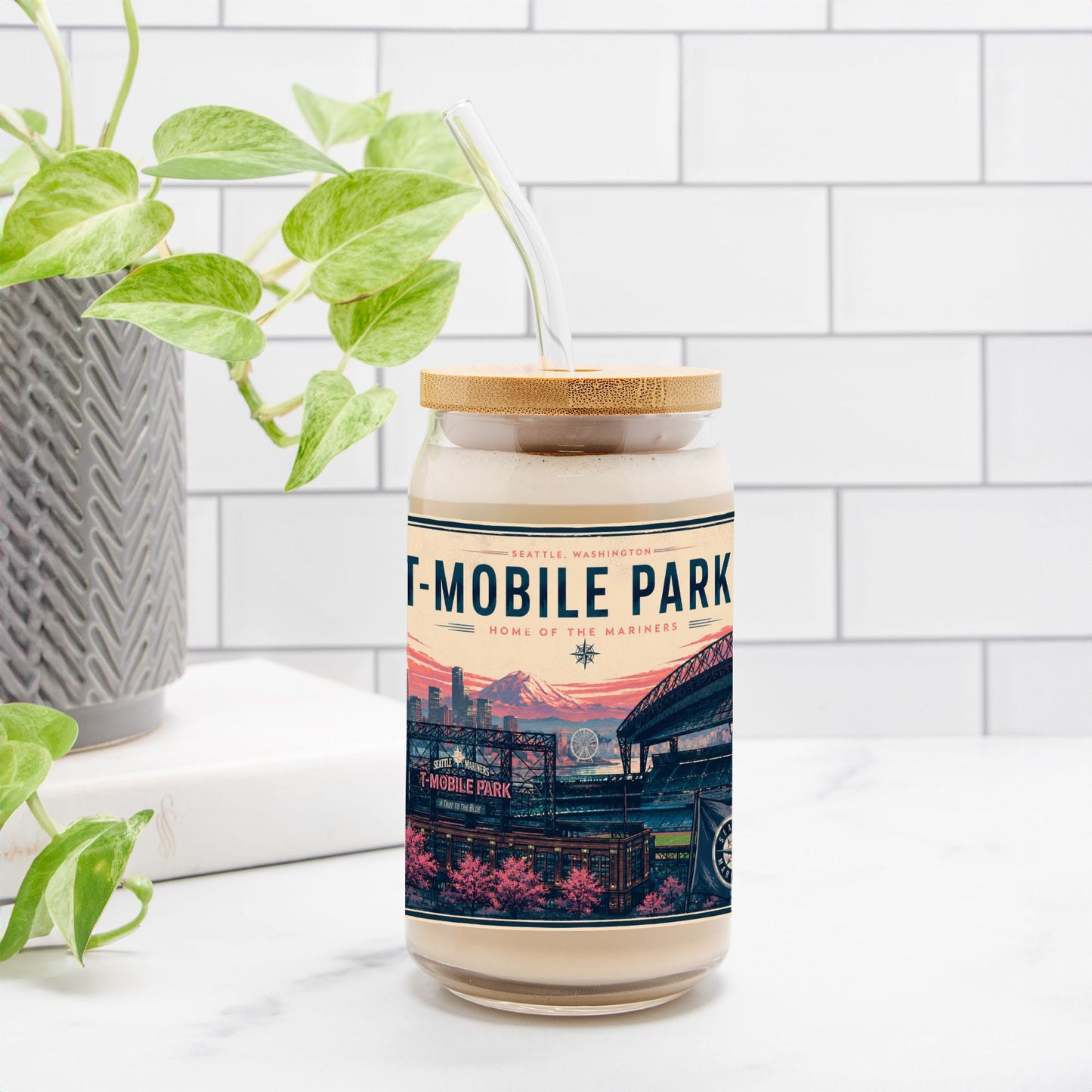 Drinking Glass with 'T-MOBILE PARK' label on a white surface with a plant in the background