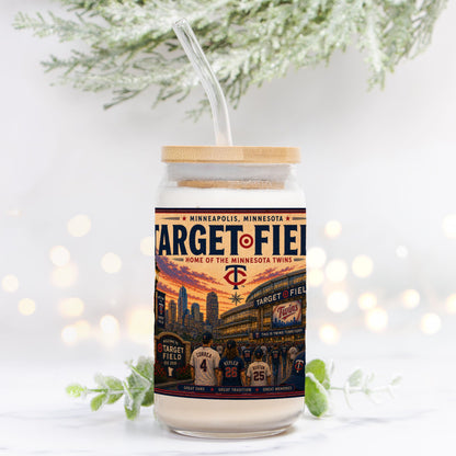 Tumbler with Target Field design and wooden lid on a white background with blurred lights and greenery.