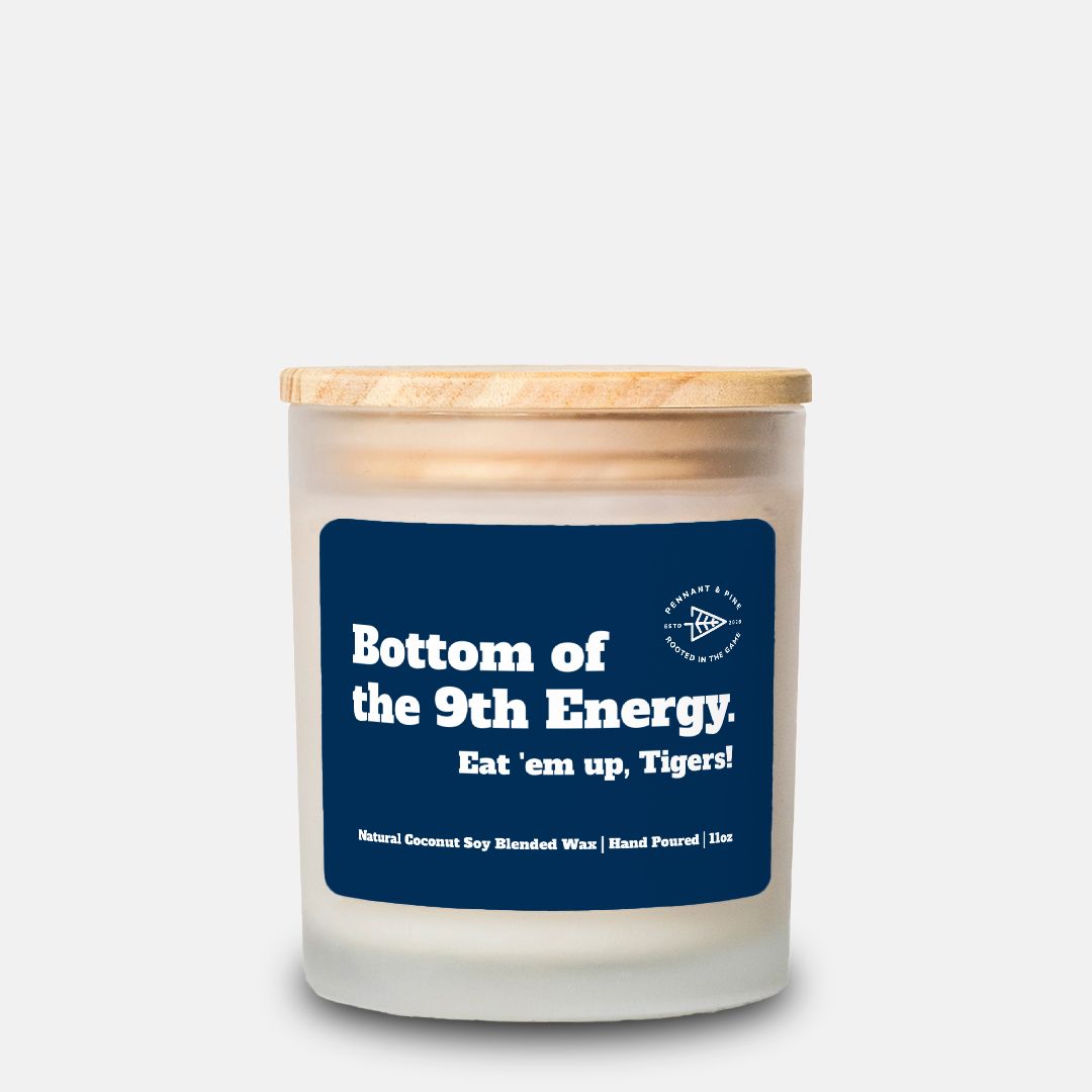 Candle with a blue label and wooden lid on a white background