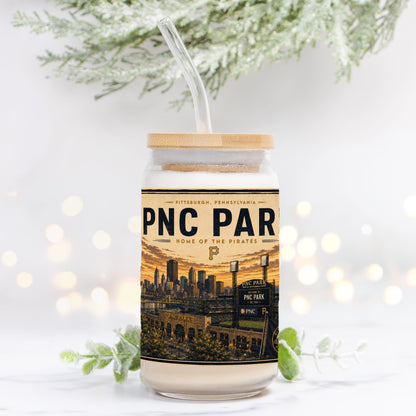 Tumbler with PNC Park design on a white background with blurred lights and greenery.