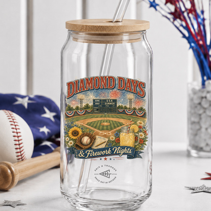 Clear glass tumbler with wooden lid featuring a baseball-themed label on a white surface.