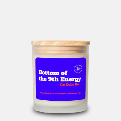 Candle with a blue label and wooden lid on a white background