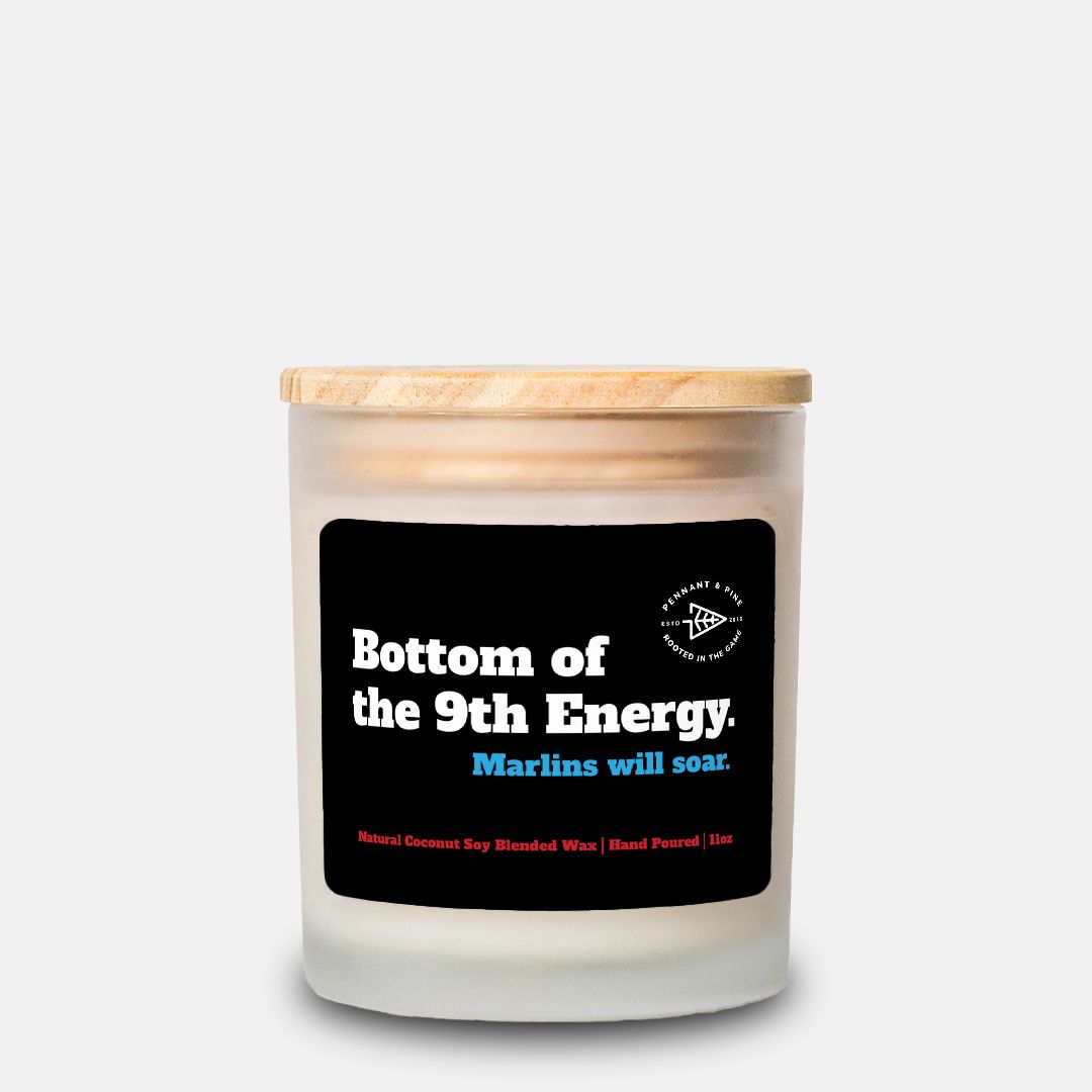 Candle with a wooden lid and black label on a white background