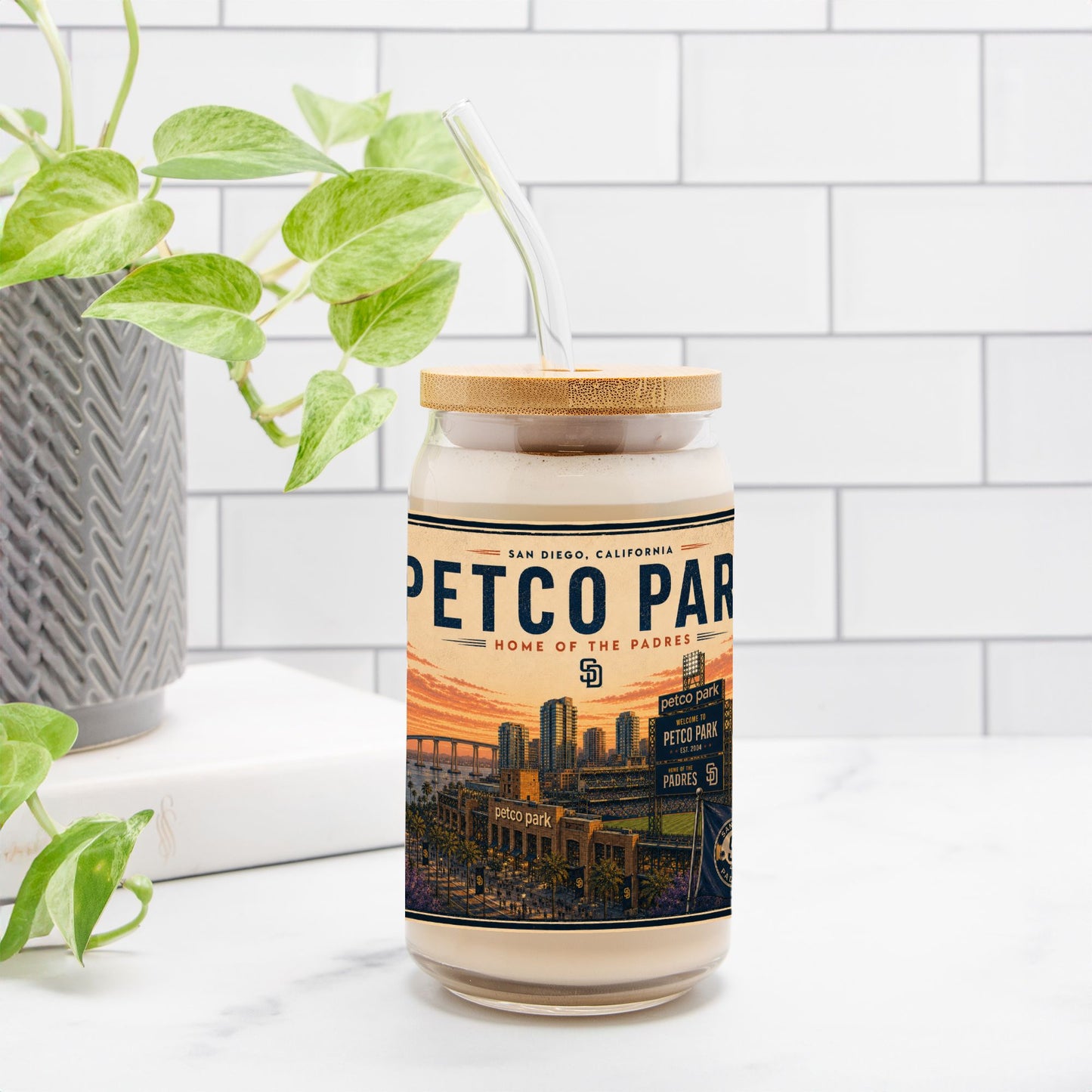 Jar with a label featuring 'Petco Park' on a white surface with a plant in the background