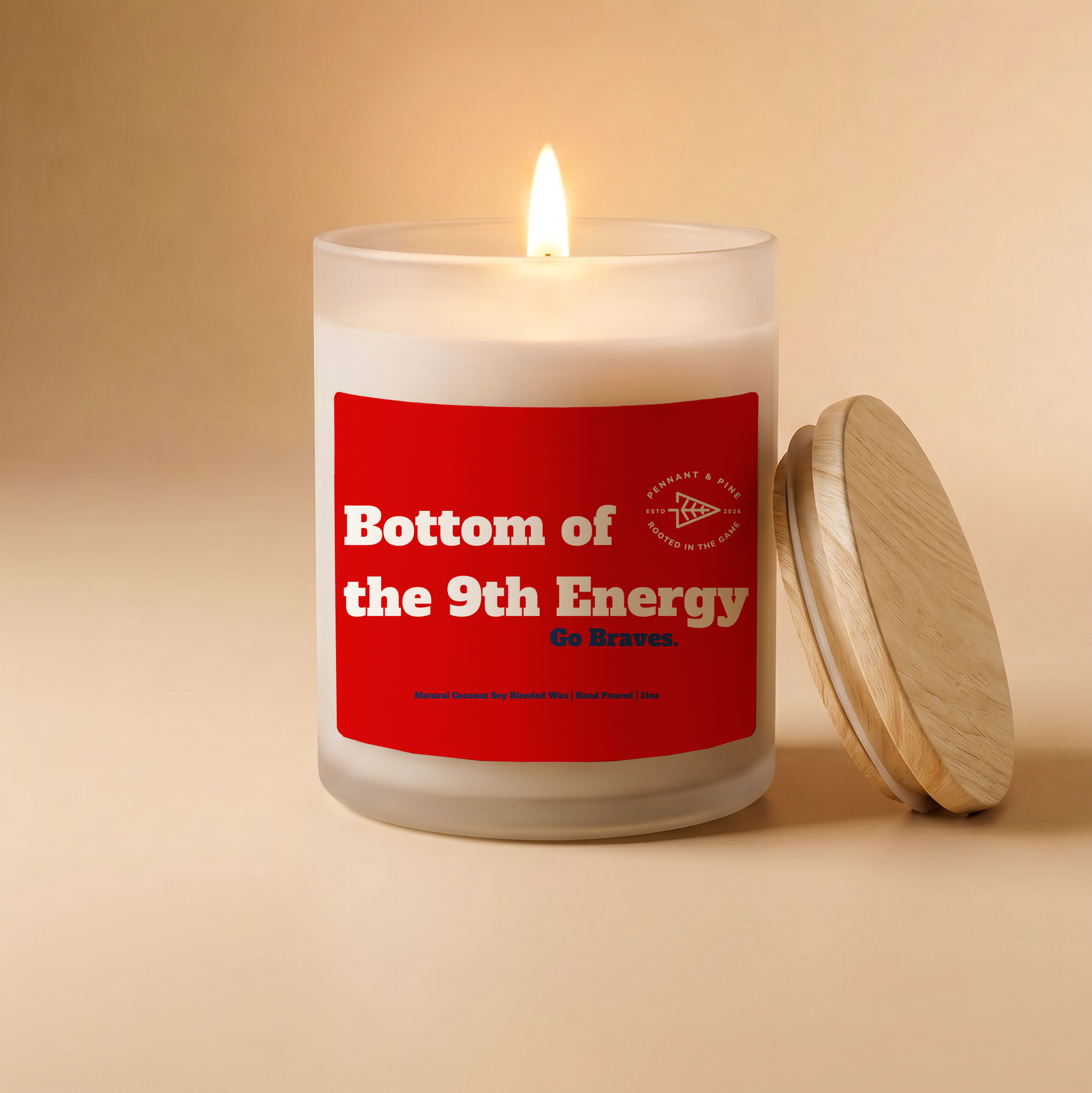Candle with a red label reading 'Bottom of the 9th Energy' on a beige background