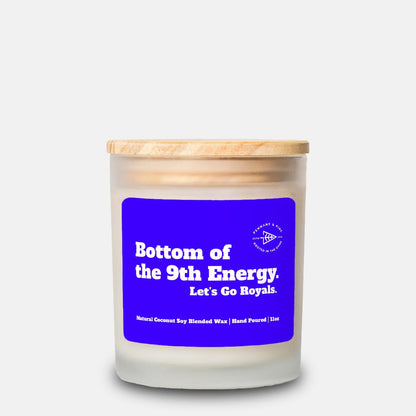 Candle with a blue label and wooden lid on a white background