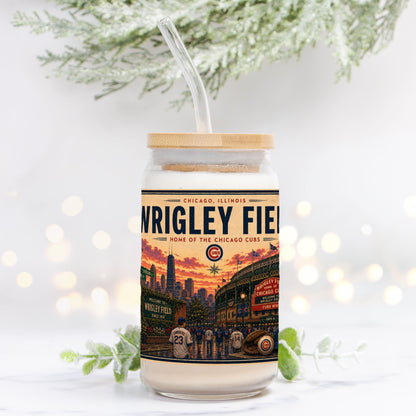Tumbler with Wrigley Field design on a white background with blurred lights and greenery.