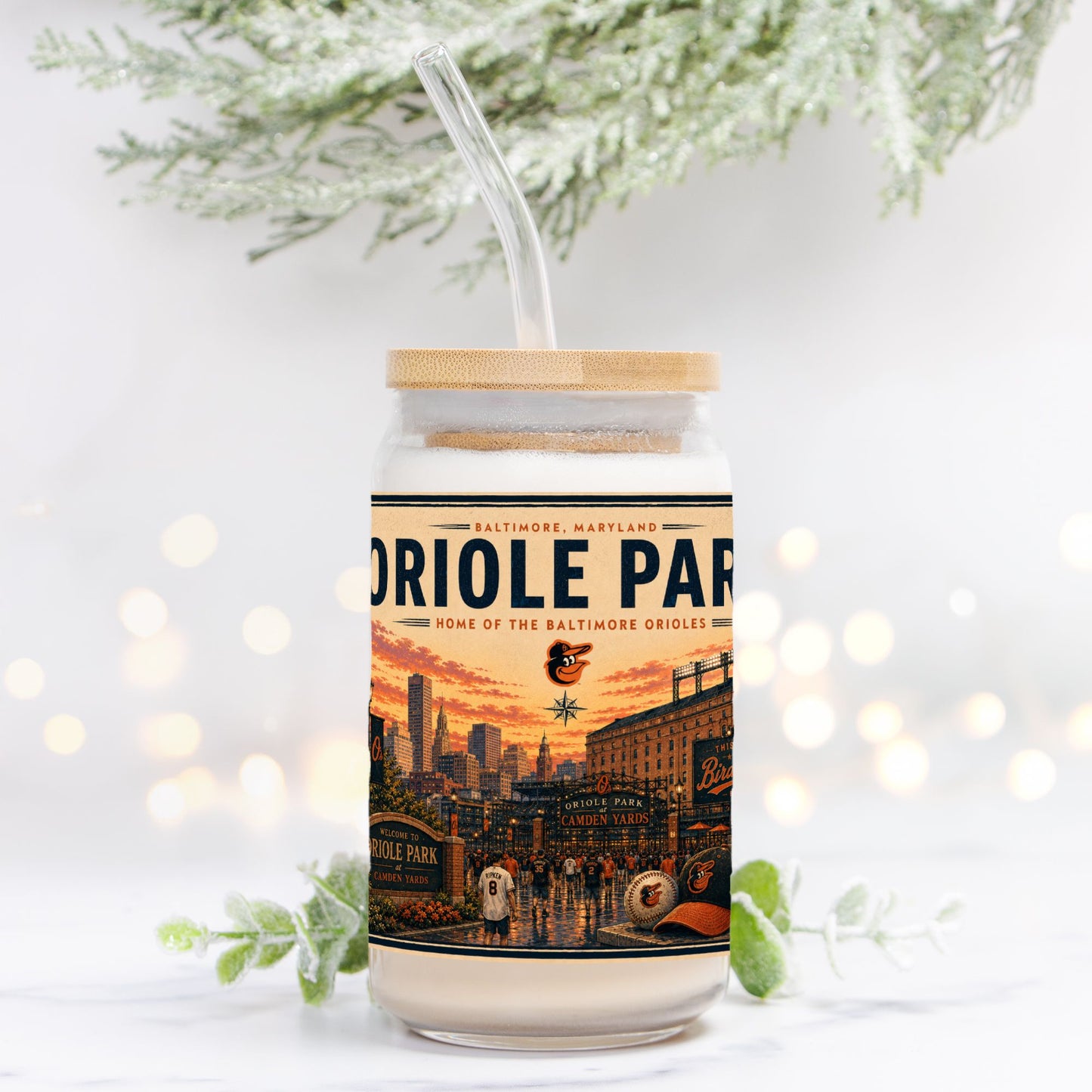 Tumbler with a design of Oriole Park at Camden Yards on a white background with blurred lights and greenery.
