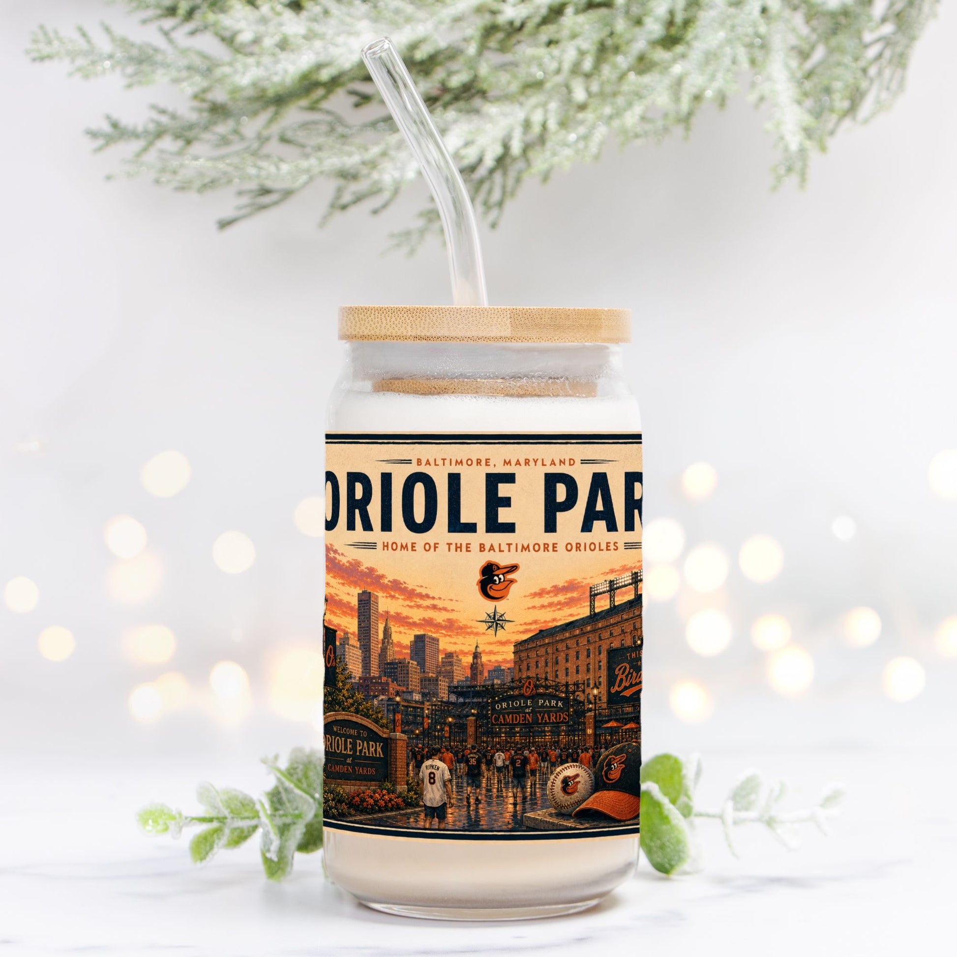 Tumbler with a design of Oriole Park at Camden Yards on a white background with blurred lights and greenery.