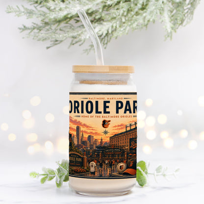 Tumbler with a design of Oriole Park at Camden Yards on a white background with blurred lights and greenery.
