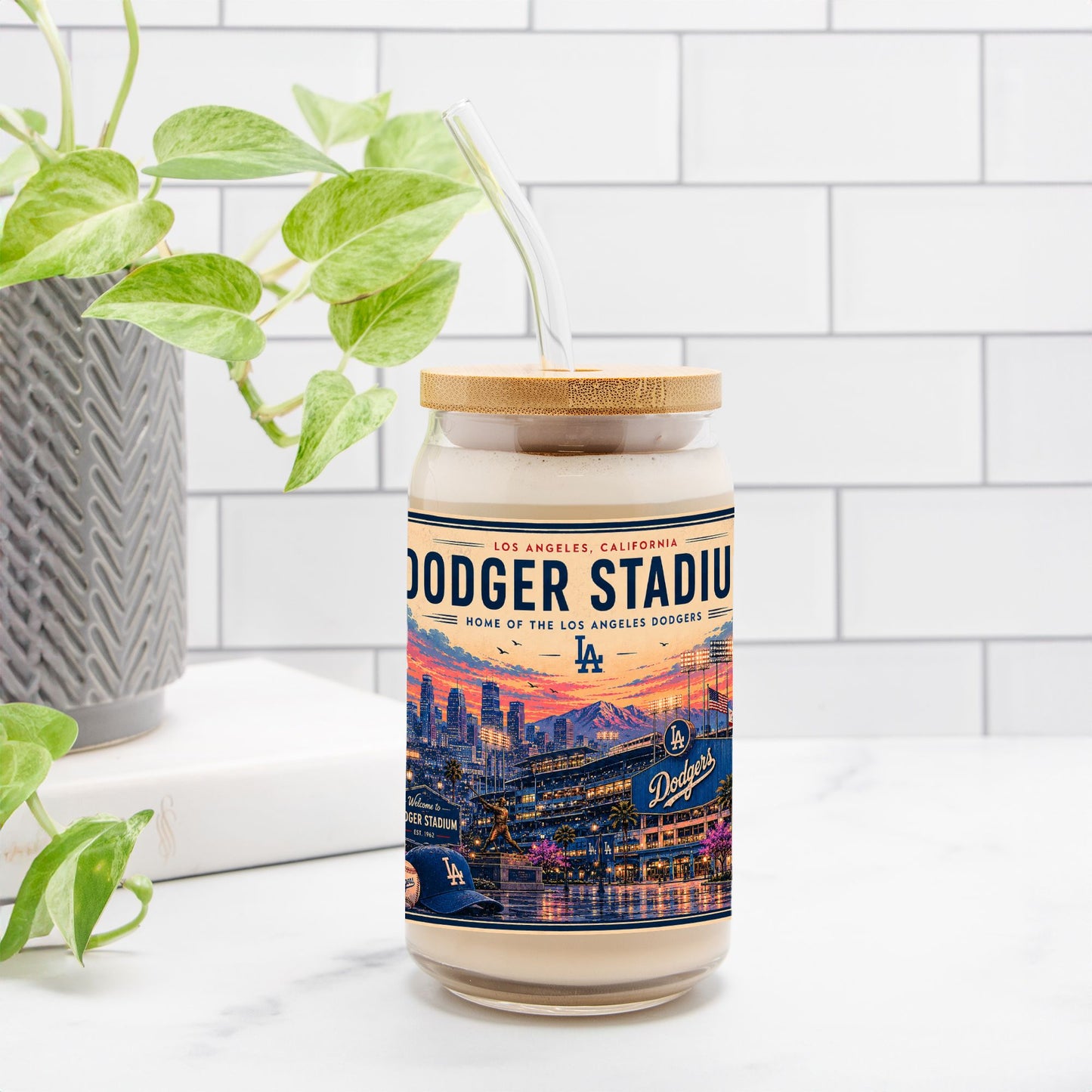 Candle with Dodger Stadium label on a white surface with a plant in the background