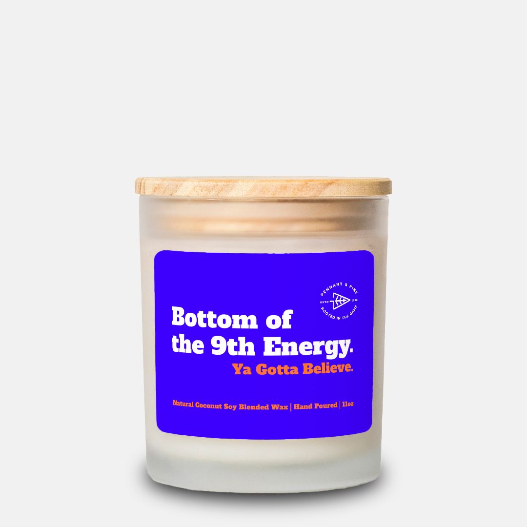 Candle with a blue label and wooden lid on a white background