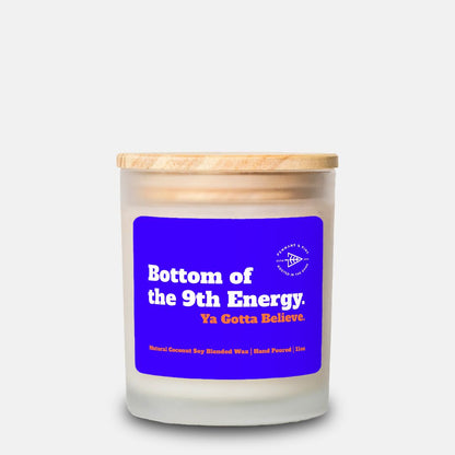 Candle with a blue label and wooden lid on a white background