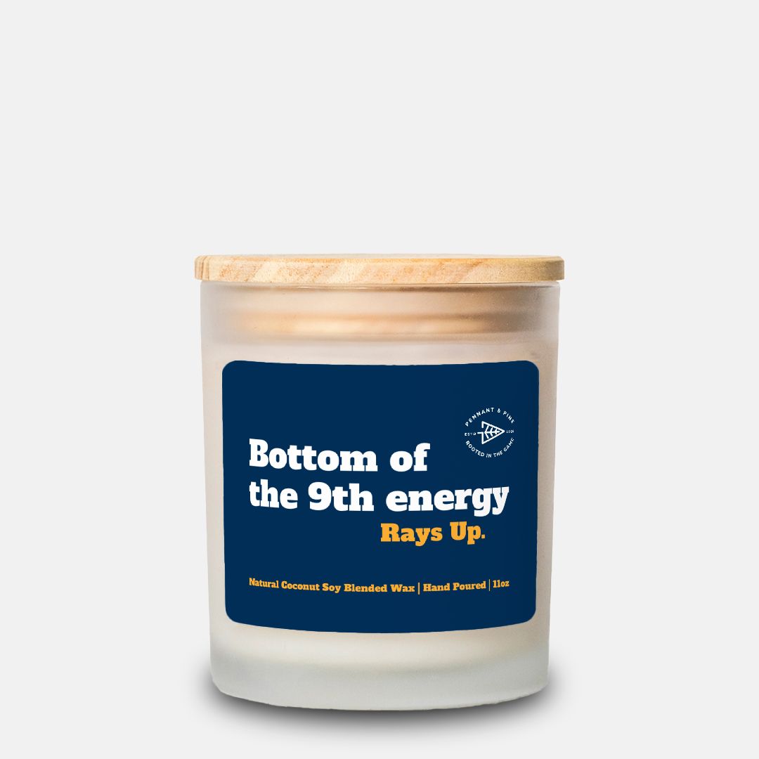 Candle with a wooden lid and blue label on a white background